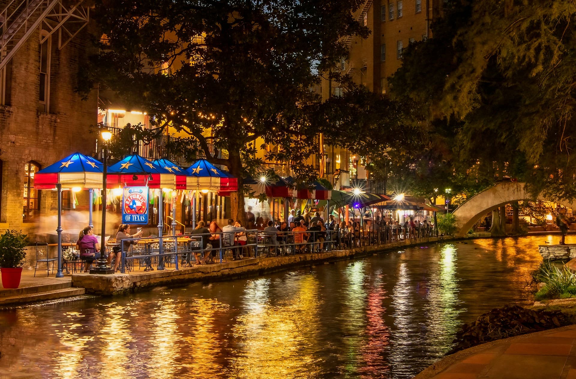 San Antonio River Walk at dawn with cypress trees and stone bridges